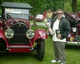 Dick Shappy holding the "Best in Show" trophy at the New England Region Cadillac & LaSalle Club show held at the Newport Abbey in Portsmouth, RI. June 18, 2002.
